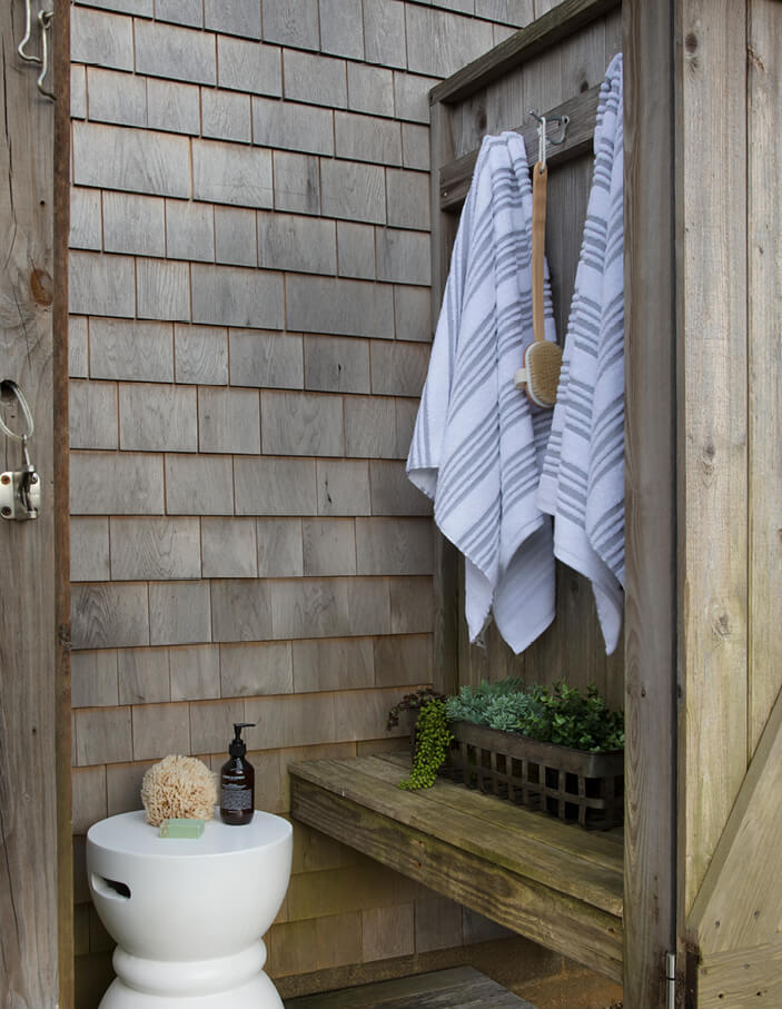 Outdoor shower with aged cedar siding at a Martha’s Vineyard summer home, designed for Cape Cod coastal living.