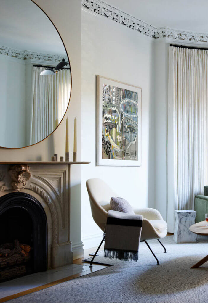 A vintage Womb chair upholstered in ivory bouclé in a historic home interior design project. Design inspiration from travel and history.