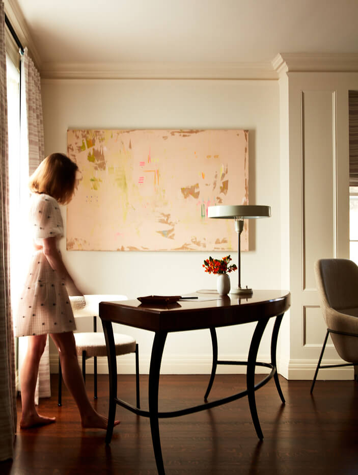 A curved vintage desk in a bedroom at a historic Boston home. Designed by an interior decorator inspired by vintage furniture.