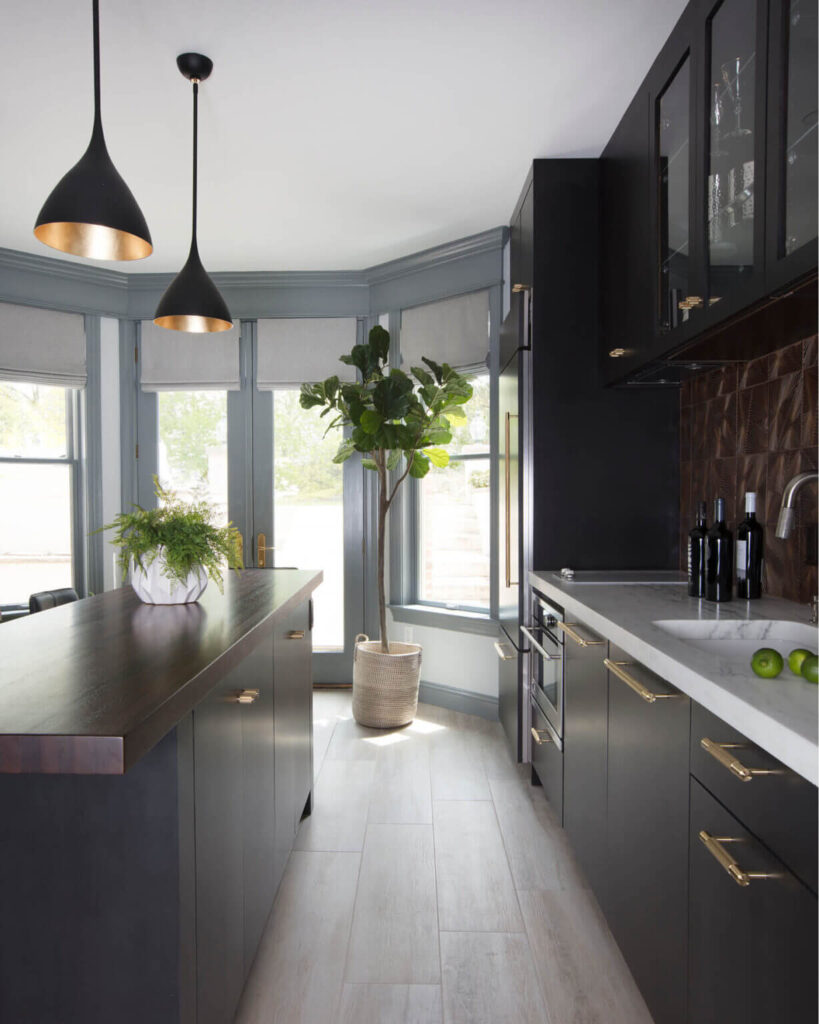 A modern Westwood kitchen with dark grey cabinets and a wood island top. Designed by a Boston kitchen designer for a cool, grey aesthetic.