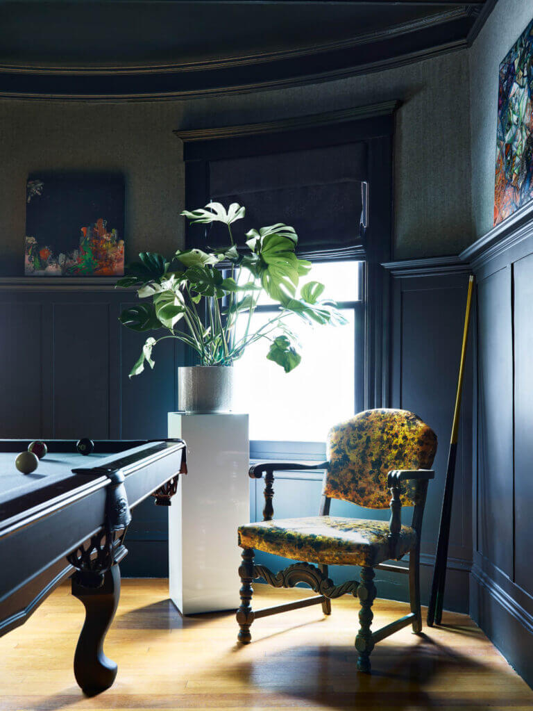 Custom interior design features dark grey herringbone fabric wallpaper, matching millwork, and a custom linen Roman shade in a Brookline home.