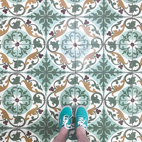 Patterned and colorful tiles in Cuban architecture, an inspiring design element captured by Sarah Scales with green Vans.