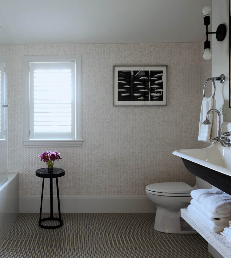 Kid-friendly bathroom in a historic Hingham home with mosaic tile floors, penny tile walls, and black-and-white design by a Boston interior decorator.