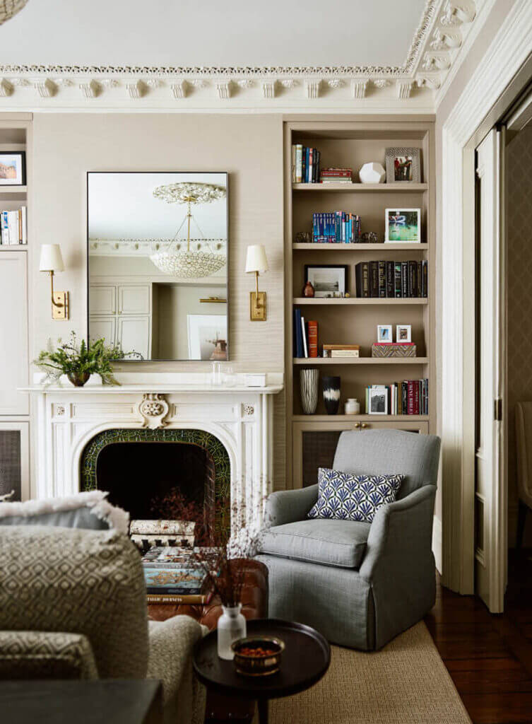 Historic brownstone renovation media room with original moldings, a classic fireplace, custom cabinets, and traditional furniture.