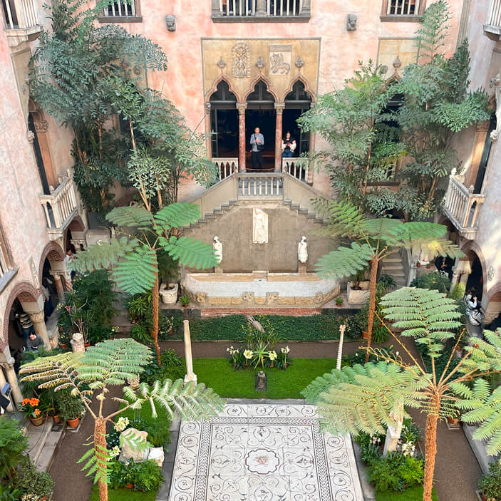 Inspiration from Boston’s Isabella Stewart Gardner Museum, featuring a pink courtyard, unique mosaic tiles, and lush tropical plants in the atrium.