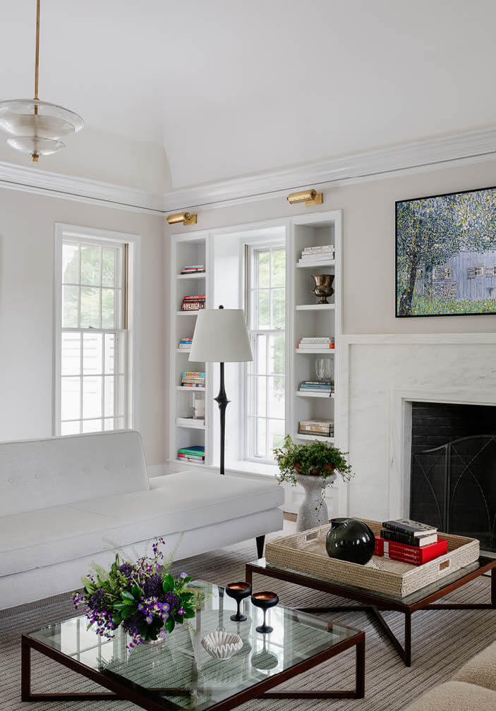 Light living room with custom marble fireplace, Arteriors pendants, and Knoll furniture by a Boston interior decorator.