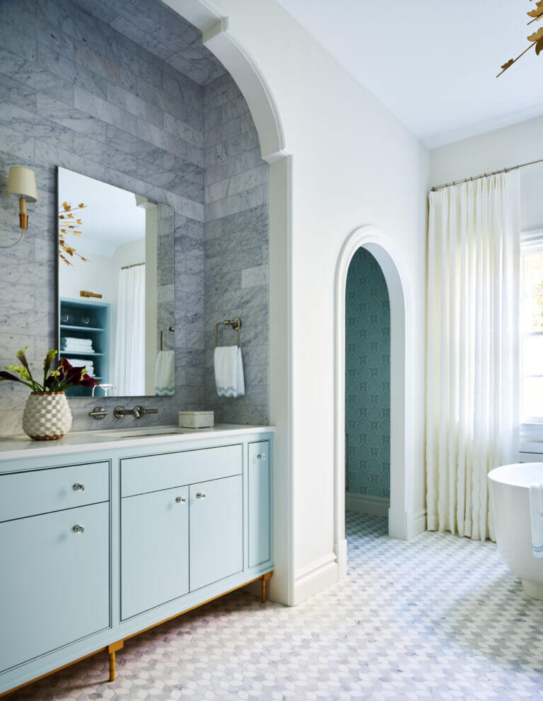 Custom light blue vanity with a marble backsplash in an alcove, marble mosaic tile flooring, and embroidered drapery. Boston kitchen and bath design.