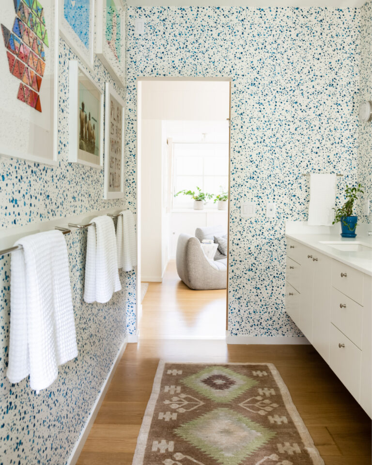 Modern kids bathroom in Hingham with spatter wallpaper, playful art, and a fun design for a new construction home.