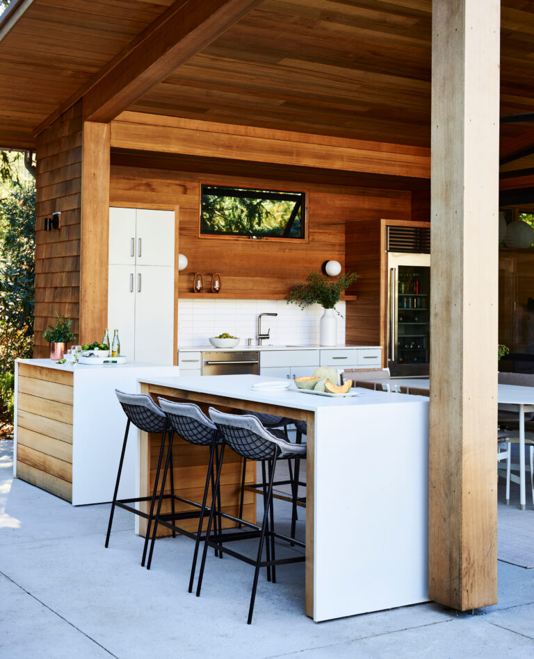 Custom outdoor kitchen design for a new construction project in Hingham, featuring built-in appliances and premium materials.