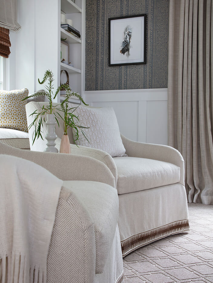 Custom upholstered chairs in a formal living space at a coastal New England home, featuring traditional decor by Boston interior design firms.