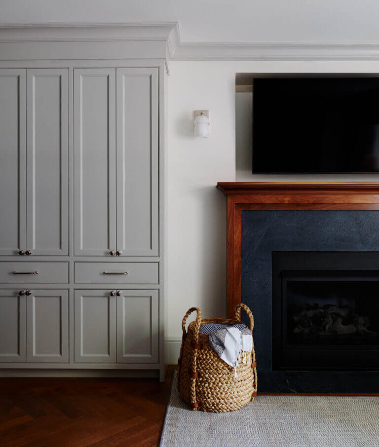 A new gas insert fireplace with a soapstone surround and walnut mantel blends seamlessly into this Boston brownstone’s historic home fireplace design.