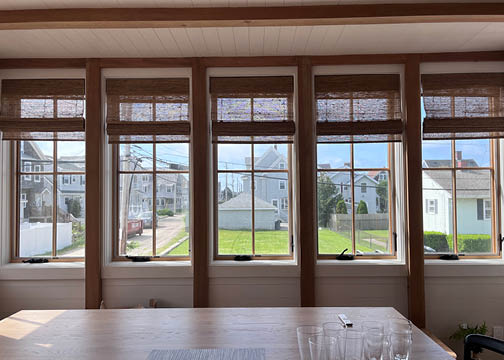 Natural wood posts and beams with white shiplap at a custom new construction beach house on Boston’s South Shore.