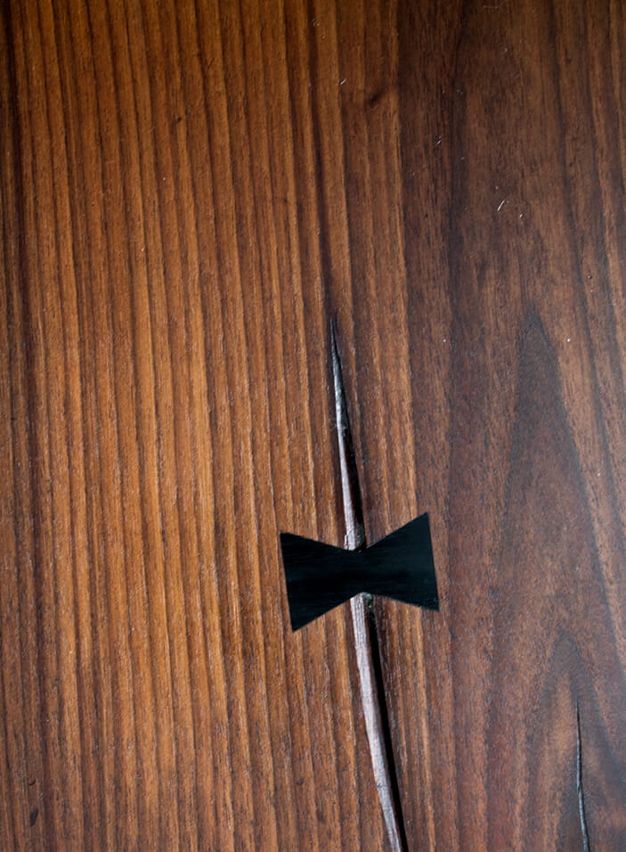 A custom walnut countertop in a South Boston design features a bow detail to prevent splitting, adding warmth and craftsmanship. Boston kitchen design