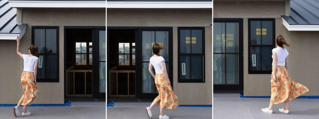 Sarah on-site at a roof deck in a new construction beach house, overseeing the Interior Design Process and reviewing sliding doors and window installation.