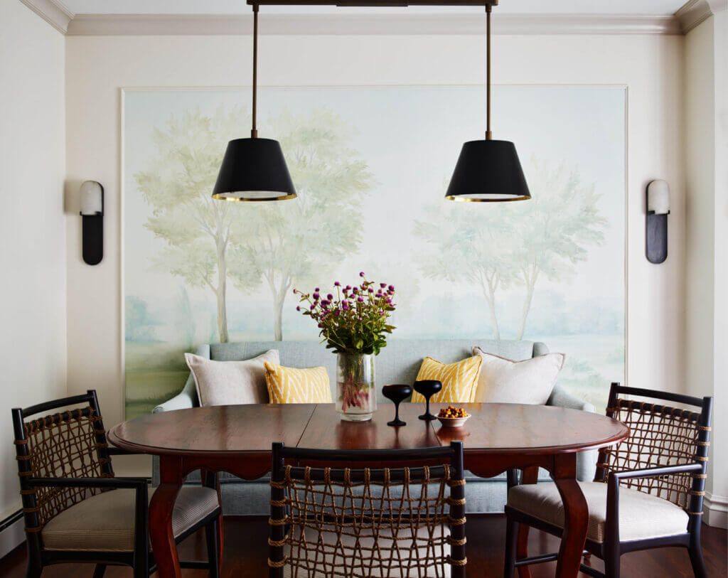 A Milton dining room with a custom Susan Harter mural, Kelly Wearstler lighting, a vintage dining table, and Palacek chairs.