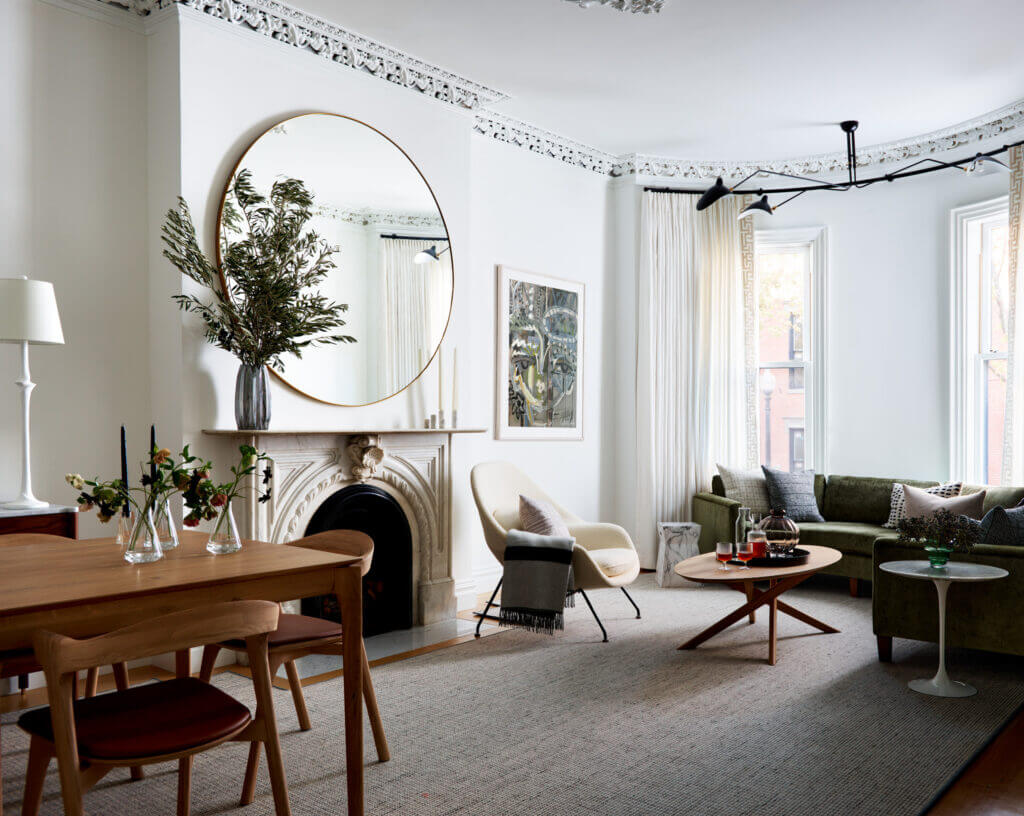 The parlor level of a Brownstone Interior Design project, featuring original plaster millwork, white walls, and a refined living and dining space.