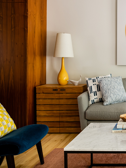Modern living room by interior decorators in Boston featuring Ellisha Alexina’s Tessa fabric in navy, styled with clean lines and custom furnishings