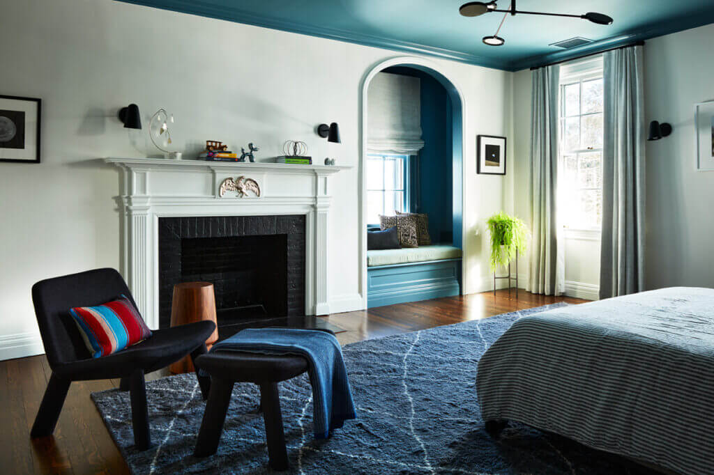 Historic Home Interior Design in a kids' bedroom with a blue ceiling, painted window niche, original Federal-style fireplace, modern furniture, and Room & Board shag rug.