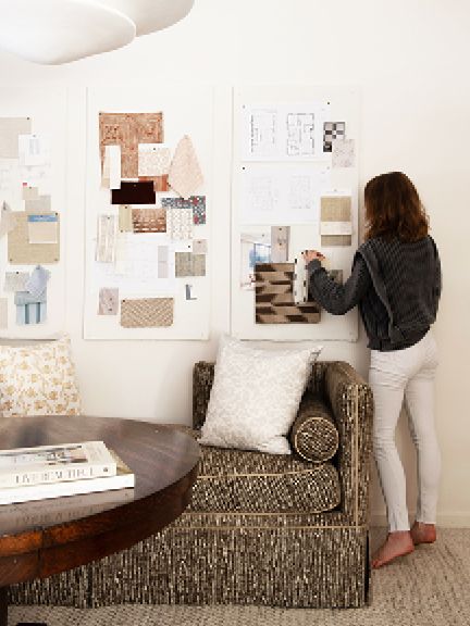 Boston interior decorator Sarah Scales in her home office with custom pillows by New England fabric designer Ellisha Alexina and Schumacher fabric on sofa