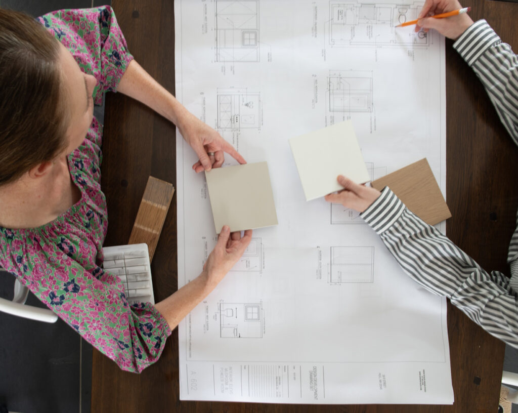 Sarah reviewing construction drawings and materials with a client, discussing the Interior Design Process for a Westwood kitchen renovation.