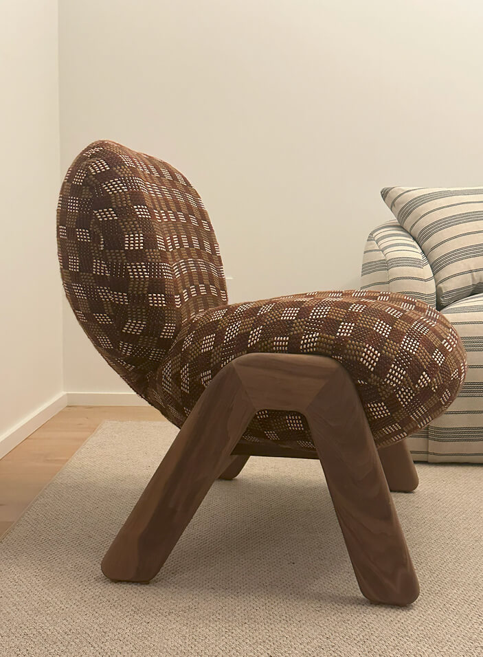 A custom lounge chair from Verellen upholstered in Pierre Frey woven wool fabric, featuring a rich burgundy, camel, and off-white pattern.