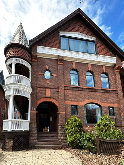 Queen Anne revival home in the Annex neighborhood of Toronto with classic brickwork and asymmetrical roofline