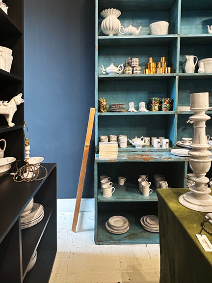 LA interior design showrooms feature aqua built-ins at Nickey Kehoe displaying French ceramics by Astier de Villatte in a high-end setting