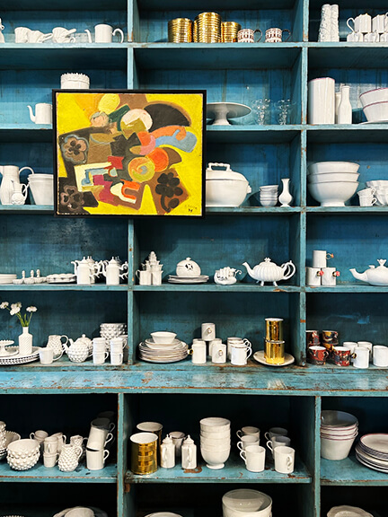 French ceramics by Astier de Villatte displayed at Nickey Kehoe’s LA showroom on open shelves