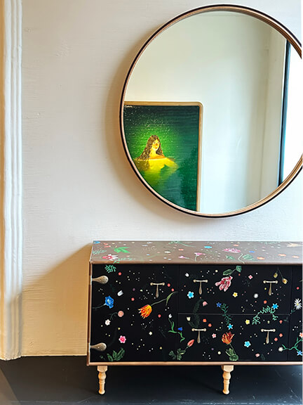 LA interior design showrooms highlight BDDW’s hand-painted Captain’s Standard credenza with a round mirror in their Los Angeles space
