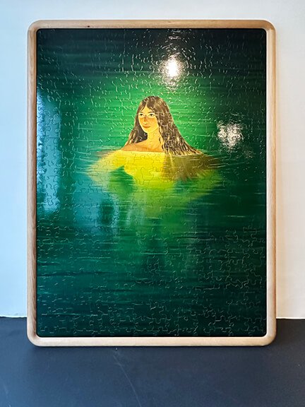 Hand-painted wooden puzzle artwork in a custom wood frame from BDDW displayed in their Los Angeles showroom