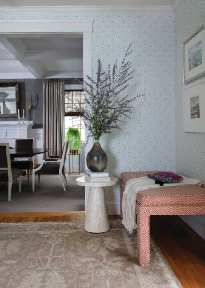 Open floor plan problems minimized with layered wallpaper and defined transitions in a Hingham foyer and dining room.