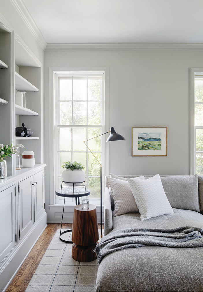 Light grey family room in a historic Hingham home with matching sectional and simple decor.