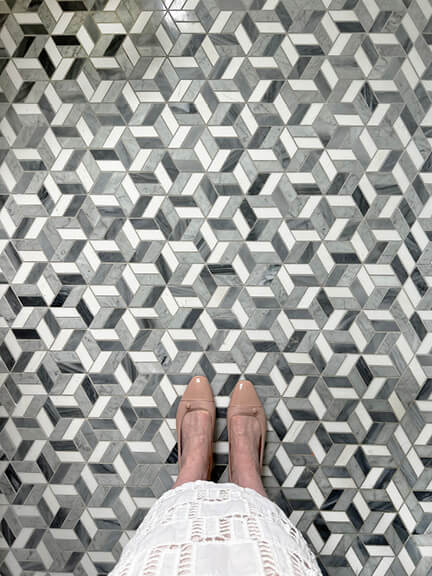 New England interior designer showcases Sacchetto ballet flats in blush pink leather on crisp grey patterned tile in a new construction home.