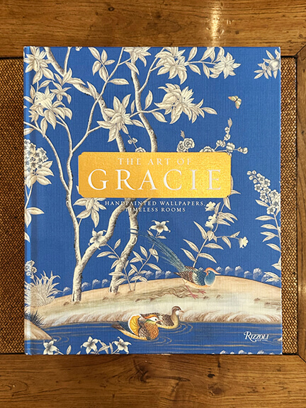 LA interior design showrooms display Gracie’s vivid blue floral wallpaper with white hand-painted birds and flowers in a traditional composition