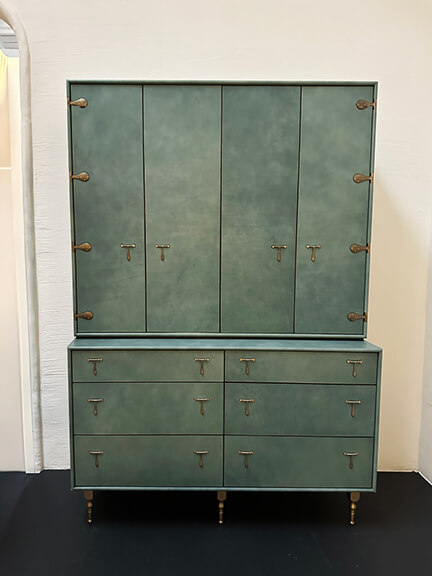 Green armoire from BDDW constructed with handstitched bridle leather and cast bronze legs in a high-end LA showroom