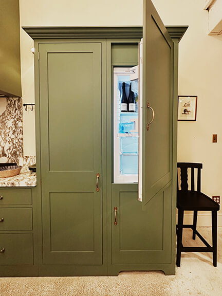 LA interior design showrooms include Nickey Kehoe’s kitchen with green custom cabinets and a panel-ready refrigerator