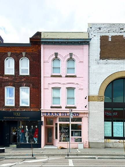 Pink-painted historic building in Rosedale, Toronto, with curved brick details on Yonge Street, home to a boutique offering handcrafted Sri Lankan goods