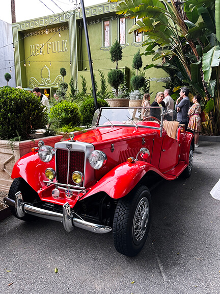 LA interior design showrooms feature Ken Fulk’s red vintage car parked outside his West Hollywood store