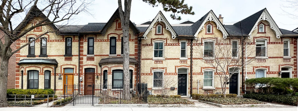 Victorian Gothic Revival row houses in Toronto featuring pointed gables, contrasting brickwork, and detailed wooden bargeboards