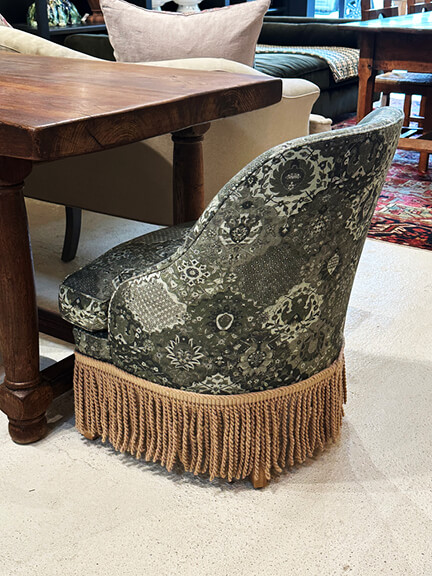 Nickey Kehoe chair with fringe trim in a California traditional interior setting blending vintage design and modern styling