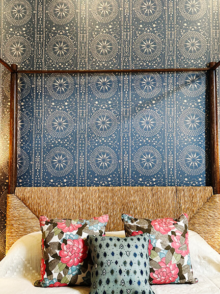 LA interior design showrooms highlight a Peter Dunham canopy bed with a woven headboard and blue and white wallpaper