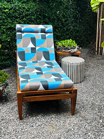 Outdoor chaise lounge by Peter Dunham with geometric patterned cushion in a high-end Los Angeles home furnishings showroom