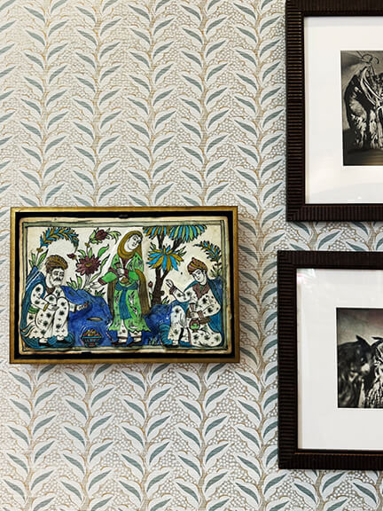 Small print Peter Dunham wallpaper with a collection of vintage art displayed in a traditional design setting