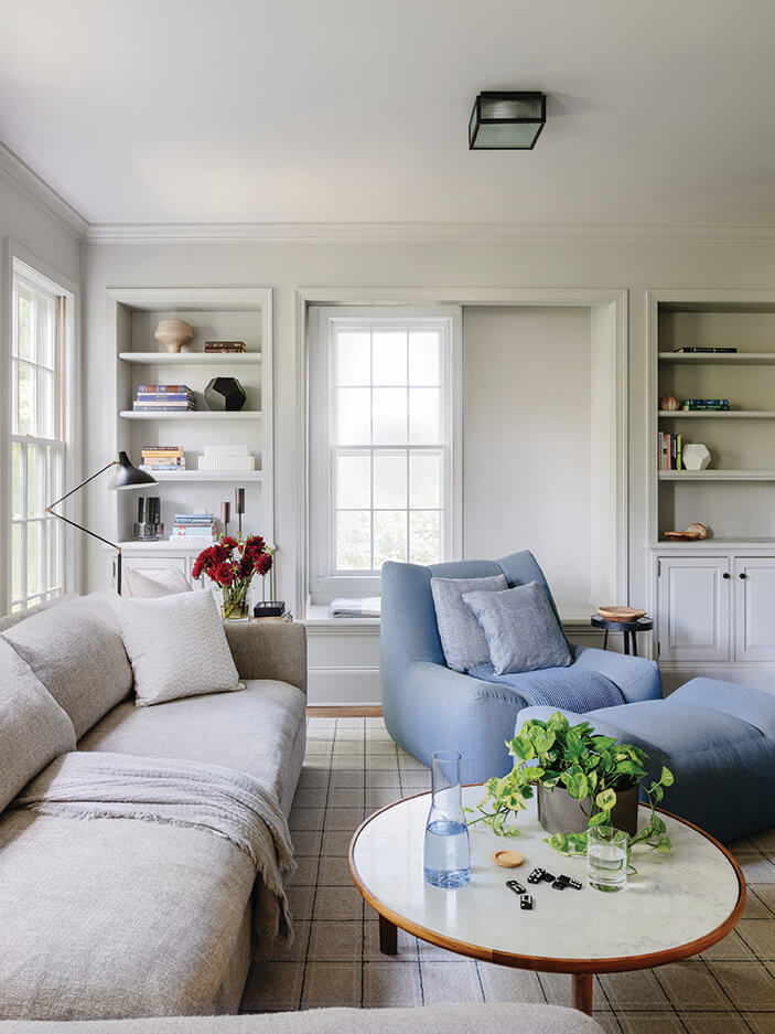 Open floor plan problems solved with modern furniture and original windows in this Hingham family room with traditional trim.