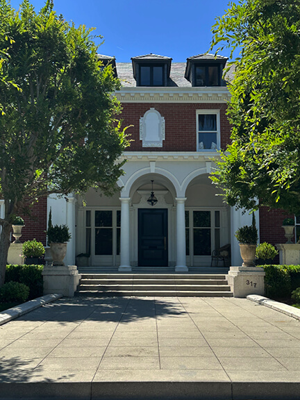 Traditional Hancock Park home in Los Angeles featuring classic arches and columns, highlighting historic residential architecture.