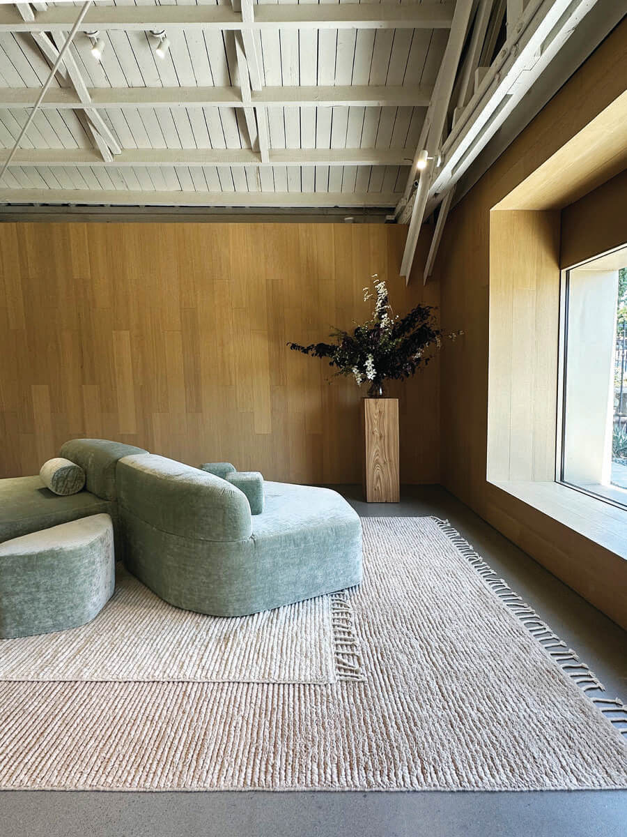 Modern furniture and layered rugs in LA interior design showrooms at Armadillo