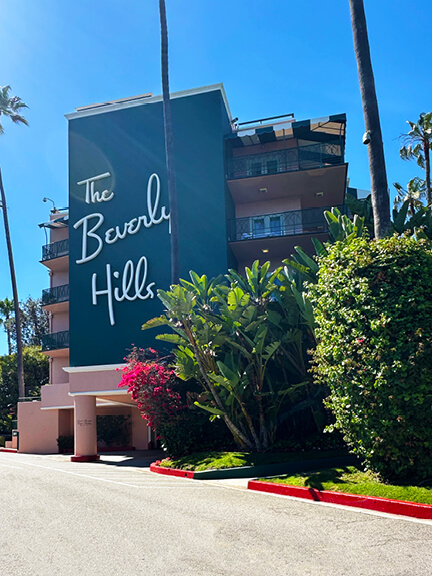 Beverly Hills Hotel exterior showing historic architecture with pink stucco, palm trees, and iconic hotel design in Los Angeles.