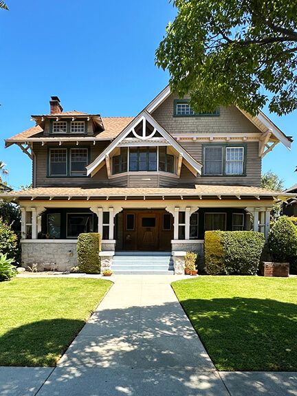 Craftsman-style historic home in Los Angeles featuring exposed wood beams, deep eaves, and a welcoming porch typical of early 20th century.