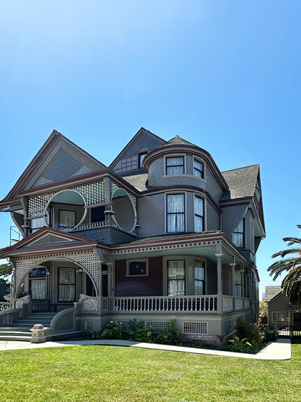 Victorian historic home design in Angelino Heights, Los Angeles, with intricate trim, a front porch, and preserved period details.