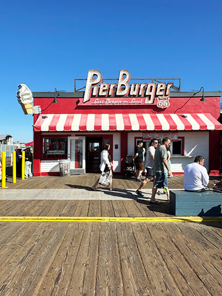 Kitsch architecture at Pier Burger on the Santa Monica Pier in Los Angeles, with striped awnings, bold colors, and nostalgic signage.